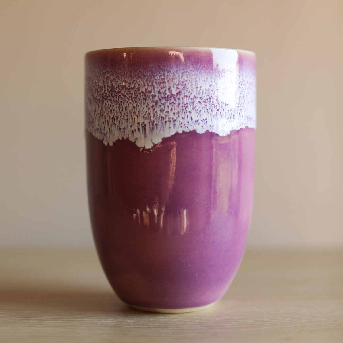 A colourful handmade stoneware drinks beaker from Glosters